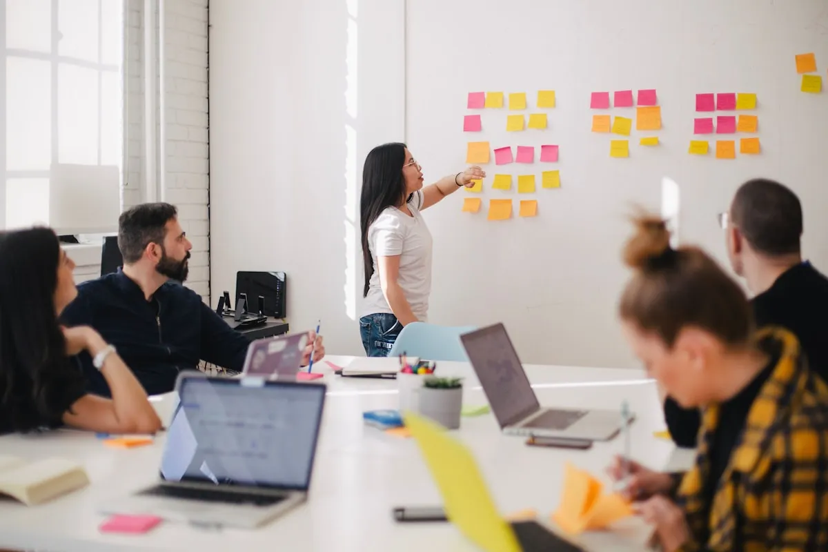 Team collaborating in a meeting discussing project management workflow
